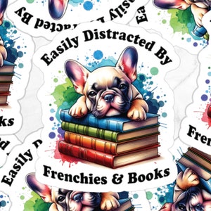 May include: A sticker featuring a watercolour illustration of a French bulldog lying on a stack of books. The text on the sticker reads "Easily Distracted By Frenchies & Books".