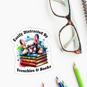 May include: A vinyl decal sticker featuring a cartoon French bulldog lying on a stack of books with the text "Easily Distracted By Frenchies & Books".
