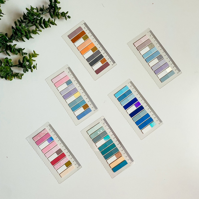 May include: Six sets of colorful patterned washi tape, each set is arranged on a white background. The washi tape is on a white background and is arranged in a rectangular shape. The washi tape is in a variety of colors, including pink, blue, green, and yellow.