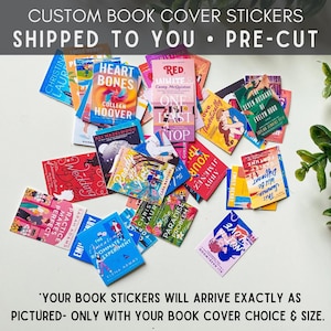 May include: A collection of pre-cut book cover stickers featuring popular book titles. The stickers are arranged on a white surface and include titles such as "Heart Bones", "Red, White & Royal Blue", "The Seven Husbands of Evelyn Hugo", and "The American Roommate Experiment".
