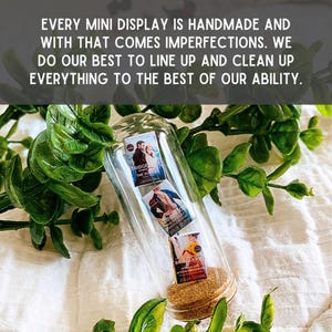 May include: A glass bottle filled with three miniature paperback books. The books are all by Julia Quinn and are part of the Bridgerton series. The bottle has a cork stopper.