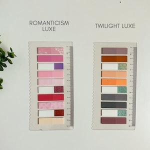 May include: Two sets of colorful sticky notes with different patterns and designs. The set on the left is labeled "ROMANTICISM LUXE" and the set on the right is labeled "TWILIGHT LUXE".