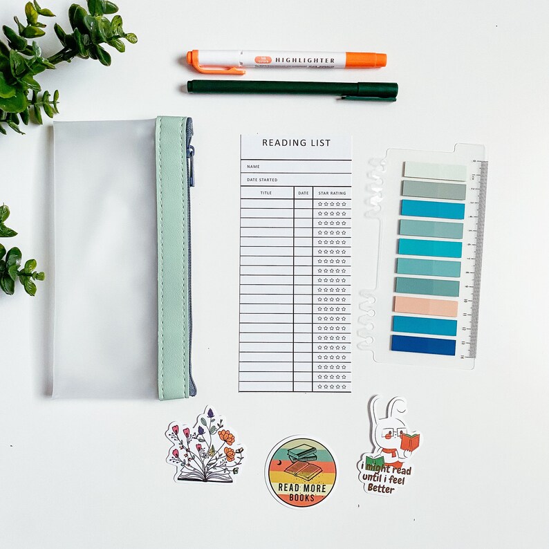 May include: A clear plastic pencil case with a mint green zipper and a reading list printable with a star rating system. There are also several stickers with book-themed designs.
