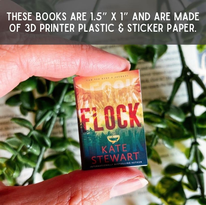 May include: A miniature book measuring 3.81 cm by 2.54 cm, crafted from 3D printer plastic and sticker paper. The cover features the title Flock by Kate Stewart, with a sunset sky over a forest landscape and the text Can you keep a secret?