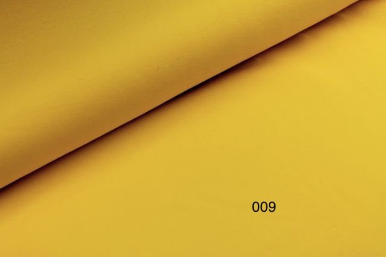 May include: A solid yellow fabric swatch with the number 009 printed on it.