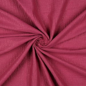 May include: A close-up of a deep pink fabric with a subtle shimmer. The fabric is soft and crinkled, creating a textured look.