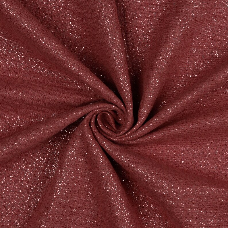 May include: Close-up of a burgundy fabric with a subtle shimmer. The fabric has a soft, textured surface.
