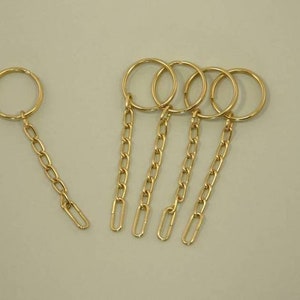 5 Schlüsselringe mit Kettchen vergoldet Bild 1