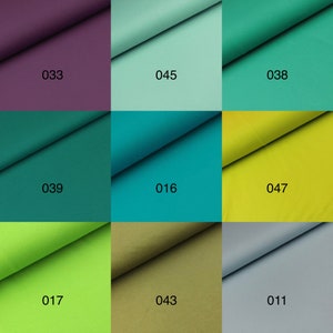 May include: Nine fabric swatches in different colors, including purple, green, teal, yellow, lime green, olive green, and gray. Each swatch has a number printed on it, such as 033, 045, 038, 039, 016, 047, 017, 043, and 011.