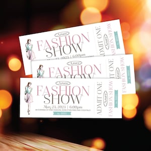 May include: Three white tickets with pink and blue text for a fashion show at Azure. The tickets read "Azure Fashion Show" and include the date and time of the event. The tickets are stacked on top of each other.