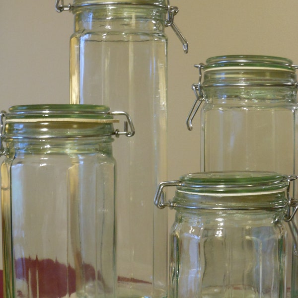 Four Glass Vintage Cylindrical Canisters with Clamping Lids