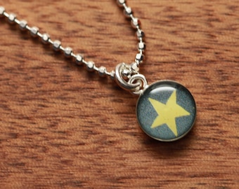 Glow-in-the-dark star necklace made from recycled Starbucks gift cards, sterling silver and resin.