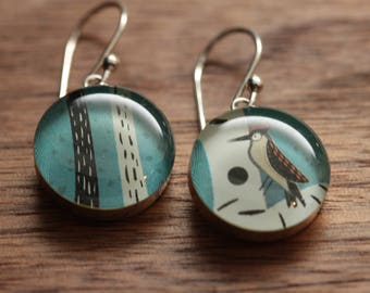 Woodpecker earrings made from recycled Starbucks gift cards. sterling silver and resin.