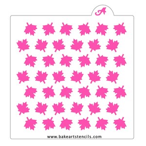 May include: A white plastic stencil with a repeating pattern of 42 pink maple leaves. The stencil is designed for use with icing, paint, or other mediums to create a decorative design on cakes, cookies, or other surfaces. The text "www.bakeartstencils.com" is printed at the bottom of the stencil.