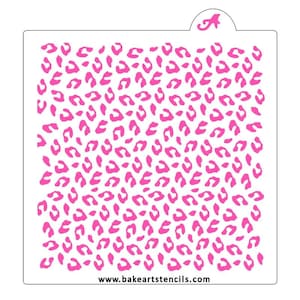 May include: A pink and white stencil with a leopard print pattern. The stencil is designed for use with icing or paint to create a leopard print design on cakes, cookies, or other baked goods. The stencil is made of durable plastic and is reusable.