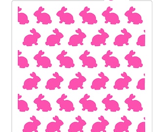 May include: A pink stencil with a repeating pattern of bunny silhouettes. The stencil is designed for use with frosting or paint to create a decorative pattern on cakes, cookies, or other baked goods. The stencil is made of durable plastic and is reusable.
