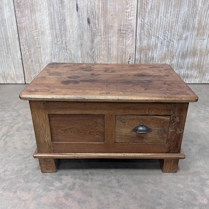 May include: A rustic wooden coffee table with a drawer and a dark brown finish. The table has a rectangular top and sits on four legs.