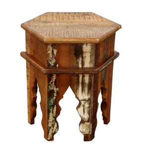 May include: A hexagonal wooden side table with a distressed, multi-colored finish. The table has a unique, ornate design with intricate carvings on the legs.