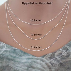 Op de afbeelding: Drie zilveren kettingen in verschillende lengtes, 16 inch, 18 inch en 20 inch, worden getoond op een model dat een geprint shirt draagt. Upgraded Necklace Chain staat bovenaan de afbeelding.