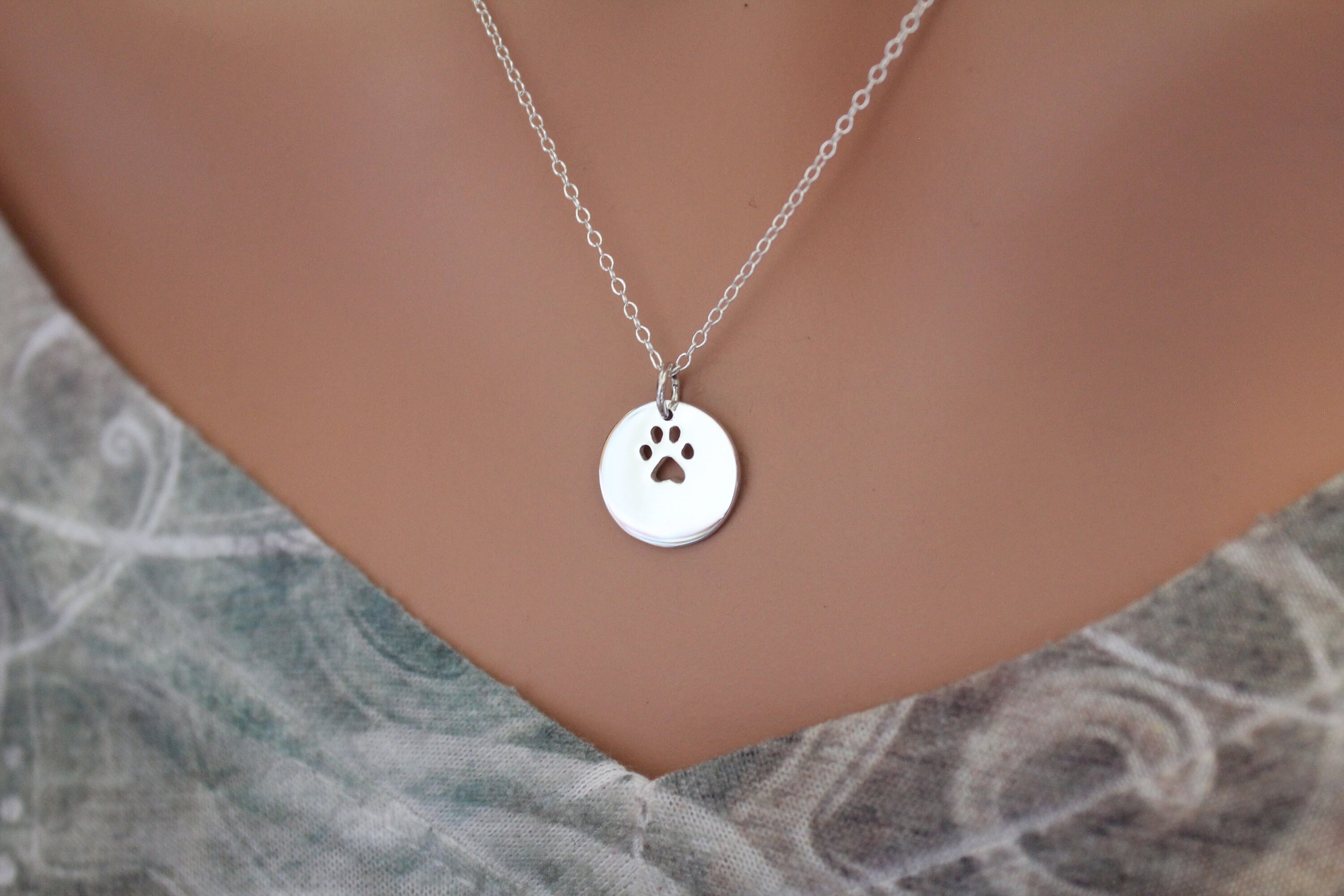 thumbnail interactive-video image 1 of Sterling Silver-Plated Hollow Paw Print Pendant Necklace – 17 Inch, Animal Rescue Benefit 1 of 5