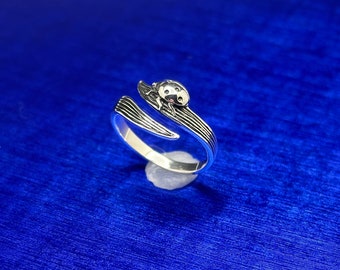 May include: A silver ring with a ladybug design. The ring is open and adjustable.