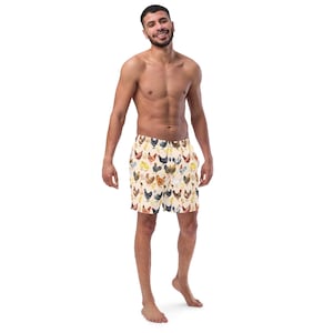 May include: A man wearing beige swim trunks with a colorful chicken pattern. The trunks have an elastic waistband and a drawstring.