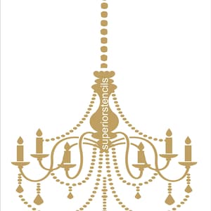 May include: A gold-colored chandelier stencil with a beaded design. The stencil is for decorative purposes and can be used to create a chandelier design on a wall or other surface.