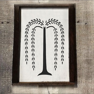 May include: A black silhouette of a weeping willow tree on a white wooden sign with a dark brown frame.