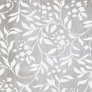 May include: A seamless pattern featuring white floral designs on a gray background. The pattern is made up of leaves and flowers, creating a delicate and intricate design.