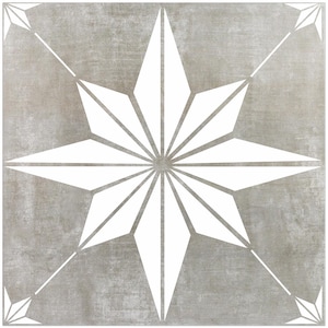 May include: A gray and white ceramic tile with a starburst design. The starburst is white and has a geometric pattern.