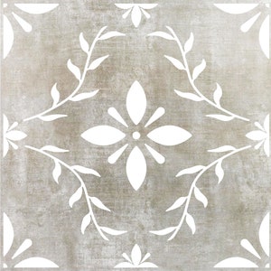 May include: A white floral design on a light brown background. The design features a central flower with four petals and a circle in the center. The flower is surrounded by four leaves on each side.