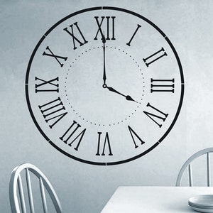 May include: Black and white Roman numeral clock face wall decal. The clock face is a circle with Roman numerals around the edge and a simple clock hand design in the center.