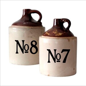 May include: Two brown and white ceramic jugs with black lettering. The jug on the left says "No. 8" and the jug on the right says "No. 7".