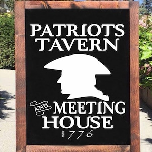 May include: A black sign with white text that reads "Patriots Tavern and Meeting House 1776". A silhouette of a person wearing a tricorn hat is above the text.