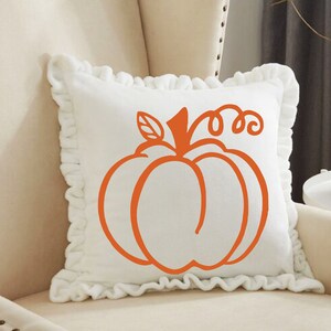 May include: White pillow with a ruffled edge and an orange pumpkin design. The pumpkin is outlined in a simple, stylized design.
