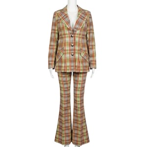 May include: A two-piece suit comprising a blazer and flared trousers in a plaid pattern of orange, green, and grey. The blazer features a notched lapel, three front buttons, and two flap pockets. The trousers have a high waist and a flared leg silhouette.