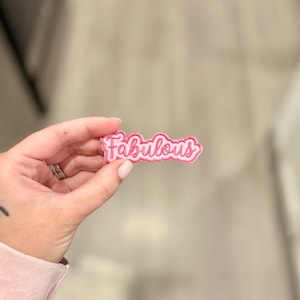 May include: Pink fabric patch with the word "Fabulous" embroidered in white.