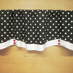 May include: Black and white polka dot valance with a white trim and two red buttons.