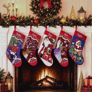 May include: Five personalized Christmas stockings hanging in a row. The first is blue with a nutcracker, the second is red with a reindeer, the third is red with Santa, the fourth is red with an angel, and the fifth is blue with a teddy bear.