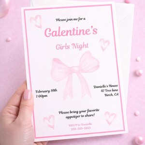 May include: A pink Galentine's Girls Night invitation with a watercolor bow and hearts. The invitation includes the date, time, and location: February 10th at 7:00pm, Danielle's House, 47 Tree lane, Birch, CA. The invitation also asks guests to bring an appetizer.