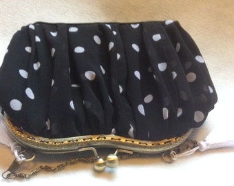 Black and white polka dot bag made from chiffon ,lined with blue satin, and white tassels.