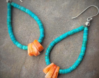 May include: A pair of turquoise and orange dangle earrings. The earrings are made of small turquoise beads and feature a cluster of orange stones at the bottom.