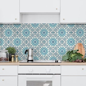 May include: A kitchen backsplash featuring a blue and white geometric tile pattern. The tiles have a repeating design of stylised flowers with a central circle.