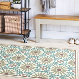 May include: A patterned floor mat with a geometric design featuring teal blue, brown, and beige colors. The mat is placed in front of a wooden bench and a metal shelving unit.