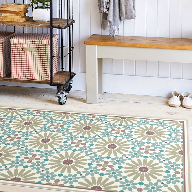 May include: A patterned floor mat with a geometric design featuring teal blue, brown, and beige colors. The mat is placed in front of a wooden bench and a metal shelving unit.