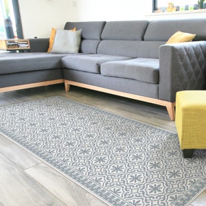 Gray vinyl rug runner with vintage tiles and decorative frame. Spanish tiles design in light gray. Vinyl floor mat, gray runner rug.