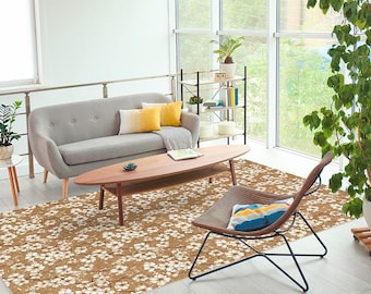 May include: A living room scene featuring a gray sofa with yellow and white pillows, a wooden coffee table, and a patterned rug. A modern chair with a striped cushion and a potted plant are also visible.