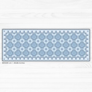 May include: A blue and white patterned rug with a geometric design. The rug is 32 inches by 86 inches and is made of a durable material.