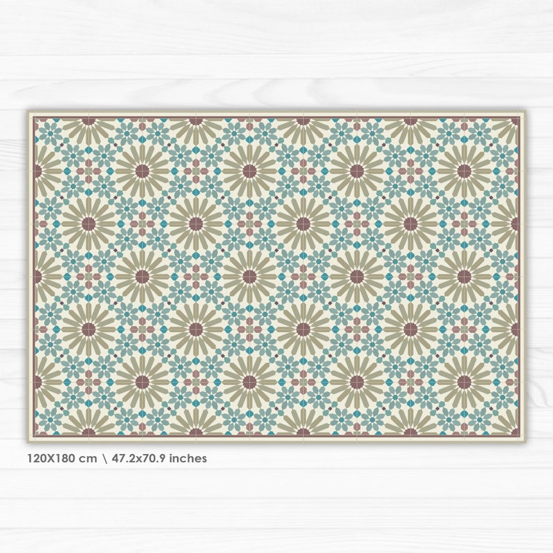May include: A geometric pattern rug with a cream background, brown, teal, and pink accents. The rug features a repeating pattern of stylized flowers. The rug measures 47.2x70.9 inches.