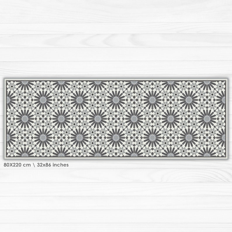 May include: A gray and white geometric patterned runner rug with a floral design. The rug is 80x220 cm or 32x86 inches.